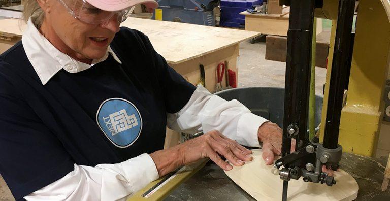 Woman working at a jig saw.