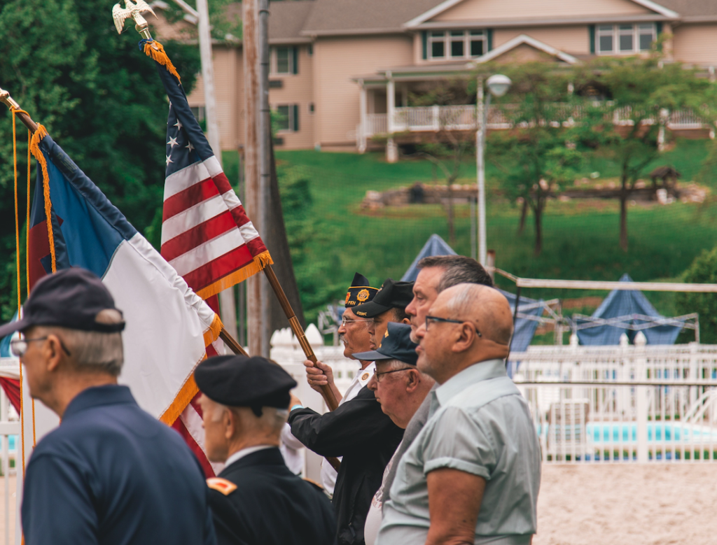 side view of men marching with flags at a parade