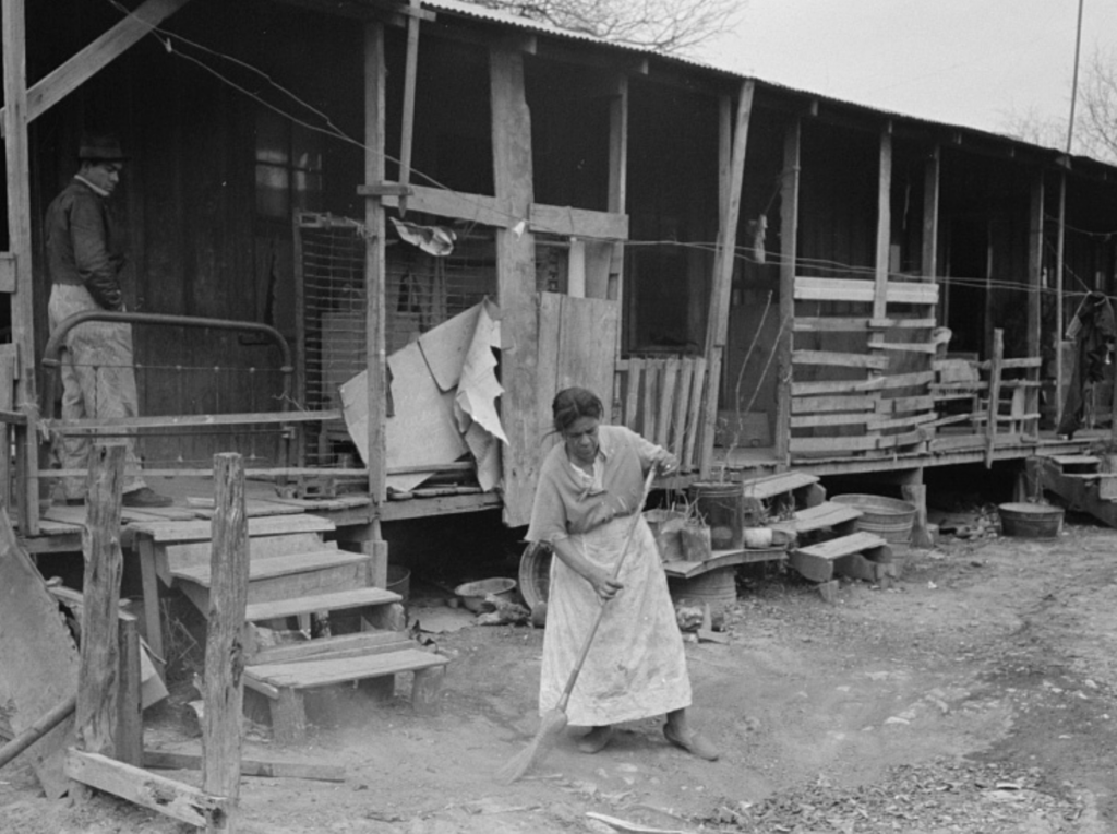 photo of a woman sweeping up trash, San Antonio, Texas, 1939